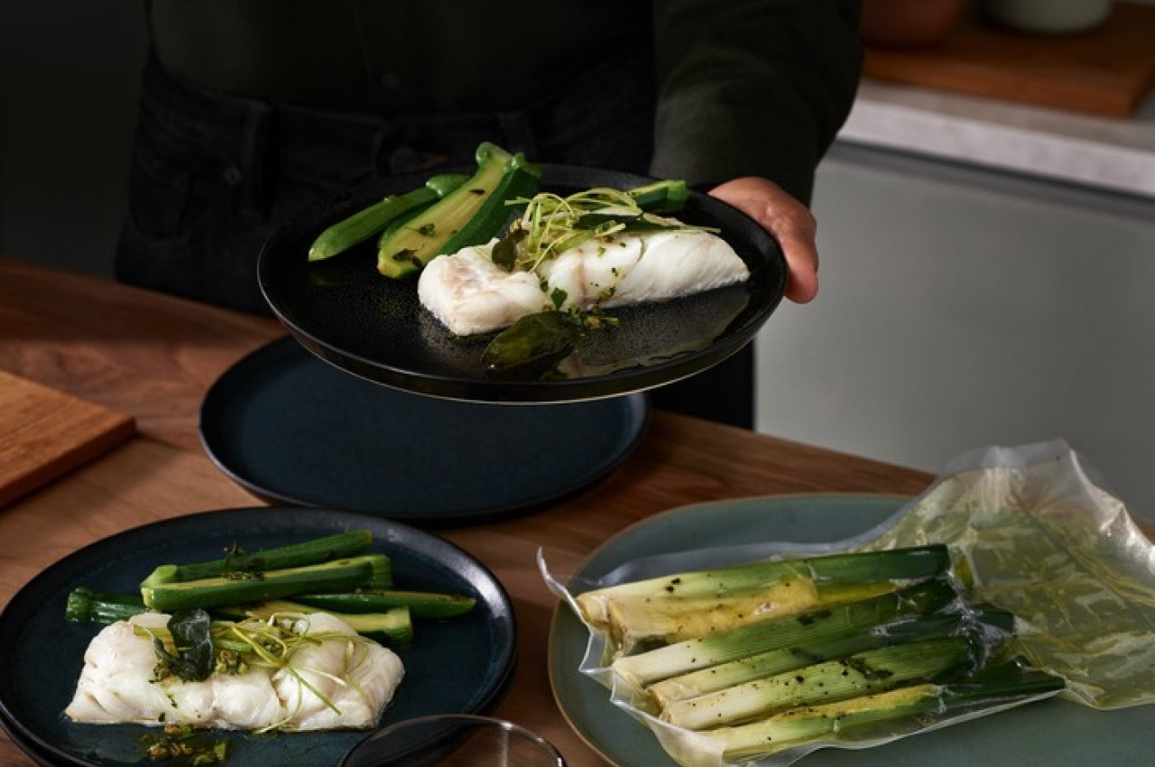 Cooked fish and asparagus in a vacuum bag